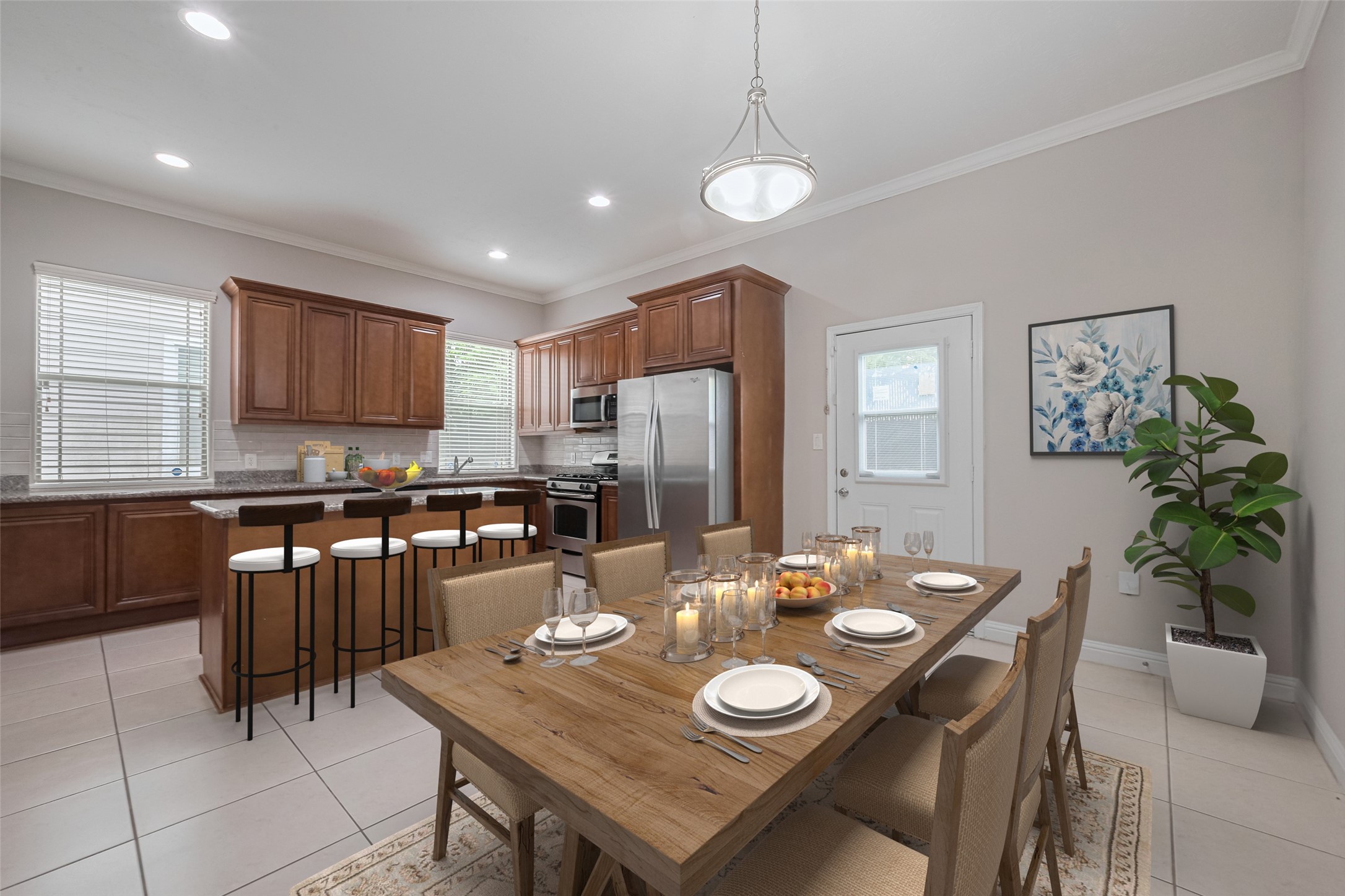 a kitchen with sink refrigerator dining table and chairs