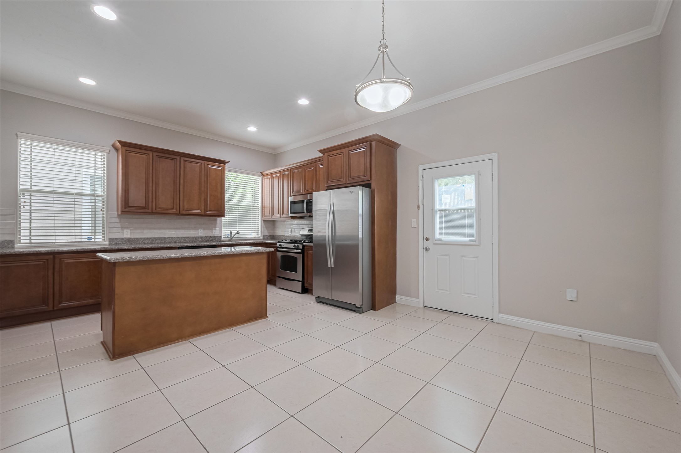 15210 Addicks Stone Drive, Unit B Houston, TX 77082 - Photo 10 of 31 a kitchen with stainless steel appliances granite countertop a refrigerator and a sink