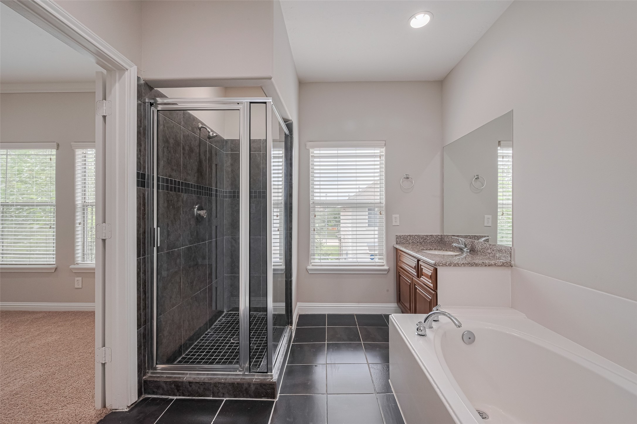 15210 Addicks Stone Drive, Unit B Houston, TX 77082 - Photo 21 of 31 a bathroom with a tub shower and sink