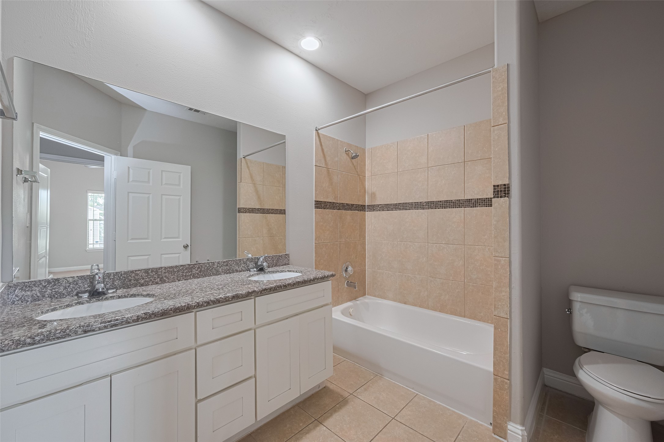 15210 Addicks Stone Drive, Unit B Houston, TX 77082 - Photo 25 of 31 a bathroom with a granite countertop sink a toilet and bathtub