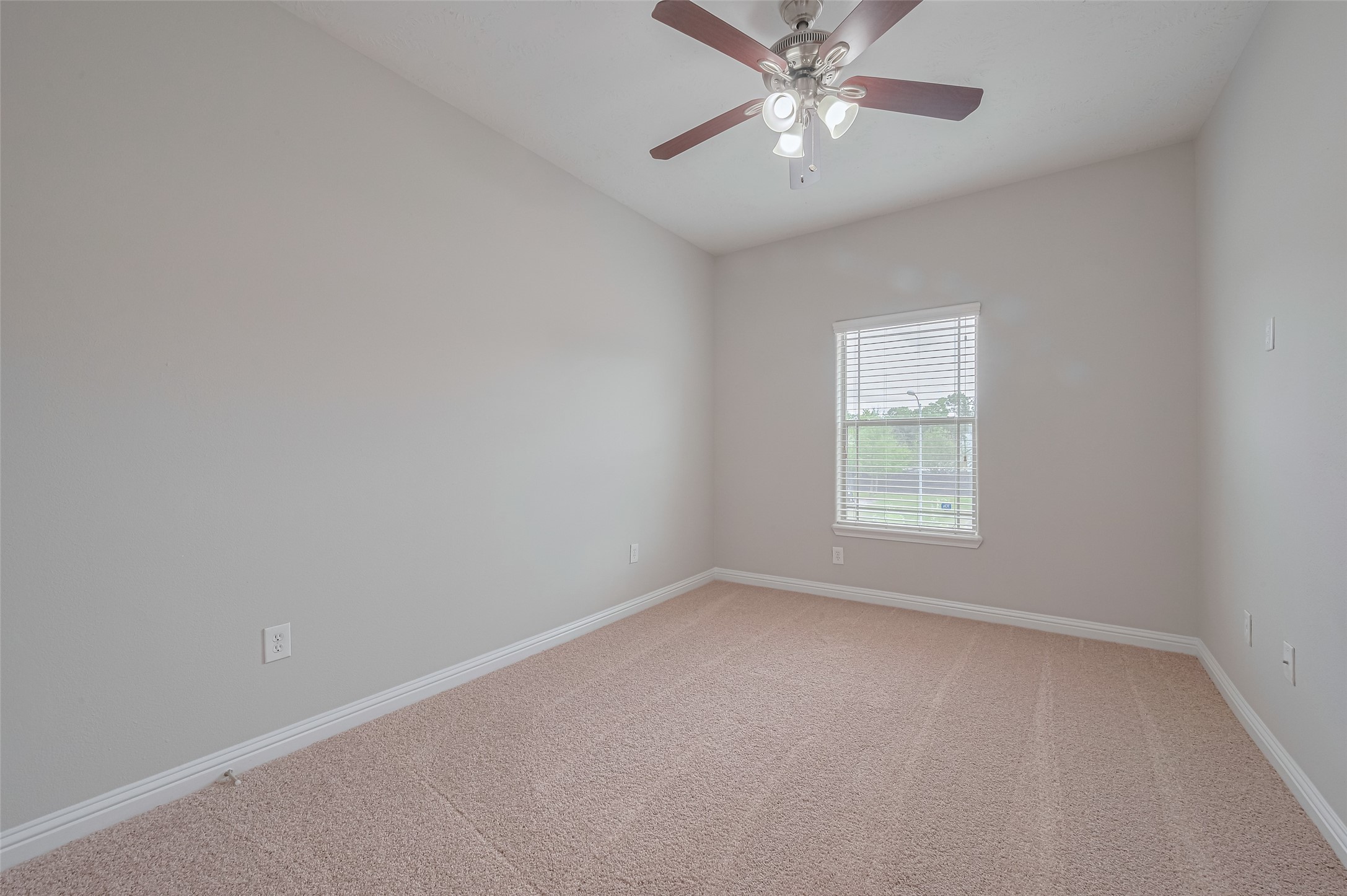 15210 Addicks Stone Drive, Unit B Houston, TX 77082 - Photo 28 of 31 an empty room with a window and a fan