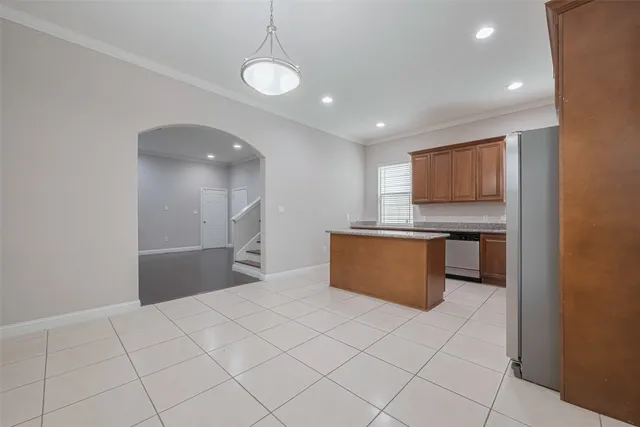 a kitchen with stainless steel appliances granite countertop wooden cabinets a stove top oven a sink and dishwasher