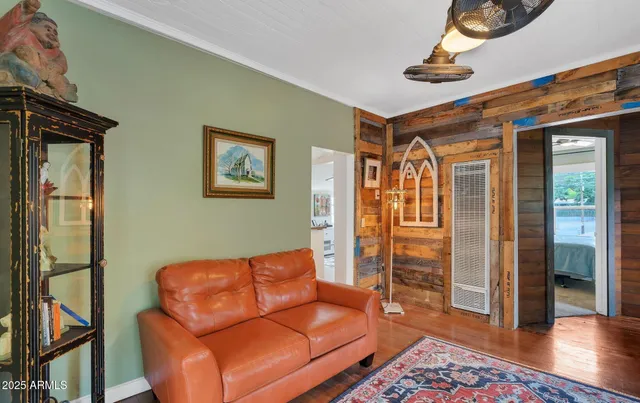 a blue couch sitting in a living room next to a window