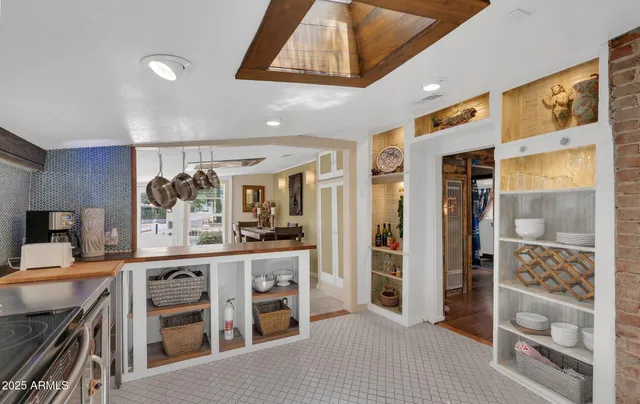 a kitchen with stainless steel appliances kitchen island granite countertop a refrigerator and cabinets