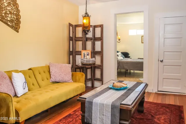 a living room with furniture and two lamp