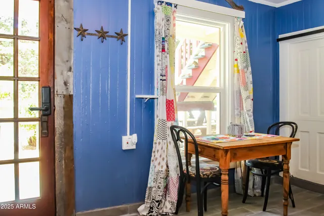 a dining room with furniture and window