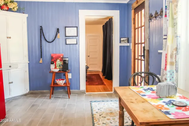 a dining room with furniture and a window