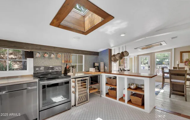 a kitchen with stainless steel appliances granite countertop a stove and cabinets