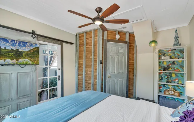 a bedroom with a bed closet and wall painting