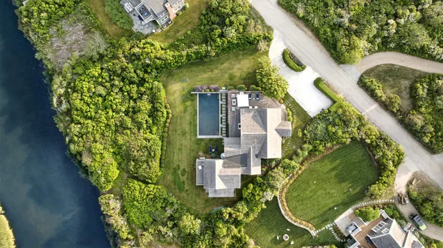 an aerial view of a house with a yard