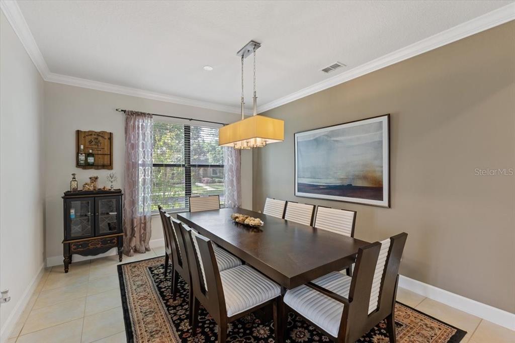 7180 Beek Street Windermere, FL 34786 - Photo 10 of 33 a view of a dining room with furniture window and wooden floor