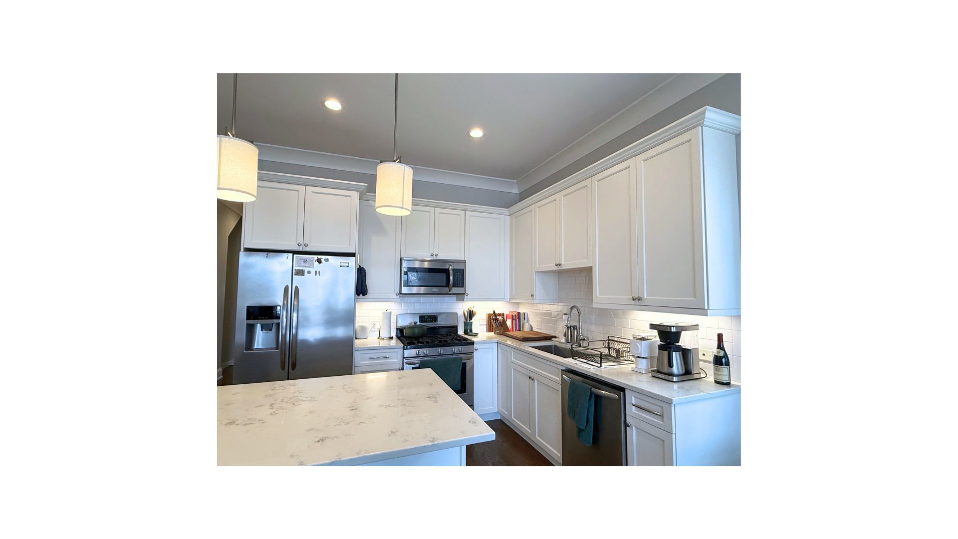 1419 West Roscoe Street, Unit 3 Chicago, IL 60657 - Photo 5 of 11 a kitchen with a refrigerator and a stove