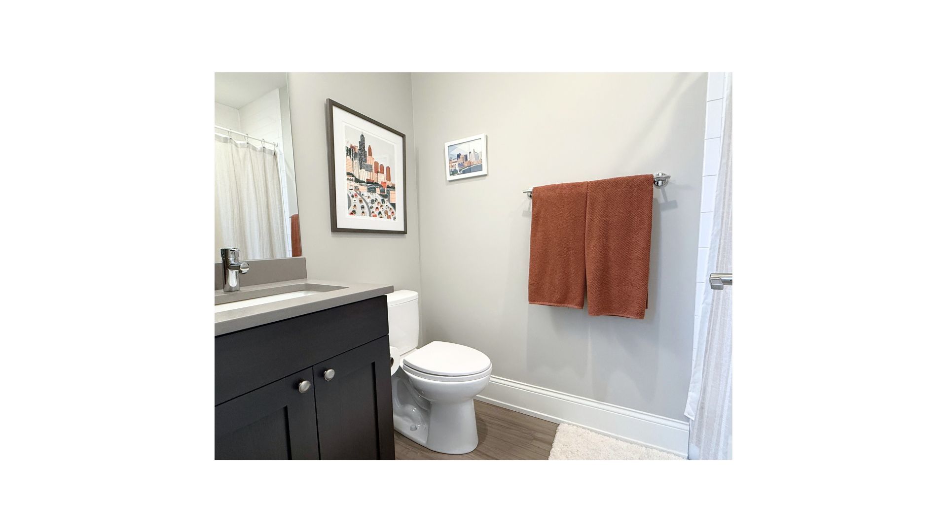 1419 West Roscoe Street, Unit 3 Chicago, IL 60657 - Photo 9 of 11 a bathroom with a toilet a sink and mirror