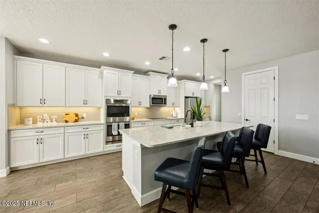 a kitchen with a table and chairs in it