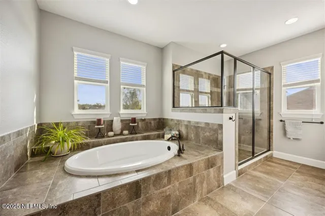 a bathroom with a tub sink and mirror