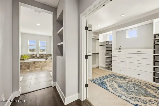 a view of walk in closet and bedroom