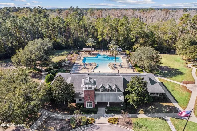 an aerial view of a house with a yard basket ball court and outdoor seating
