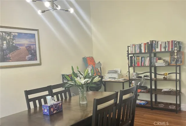 a view of a dining room with furniture and a potted plant