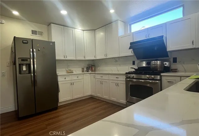 a kitchen with a refrigerator stove and sink