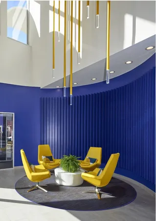 a blue chair sitting in a room next to a blue chair