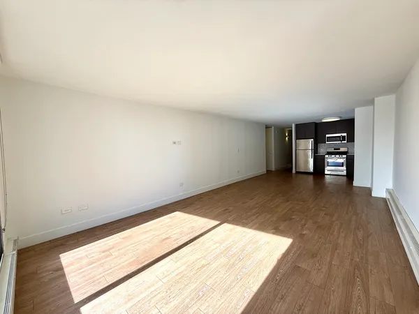 an empty room with wooden floor and closet