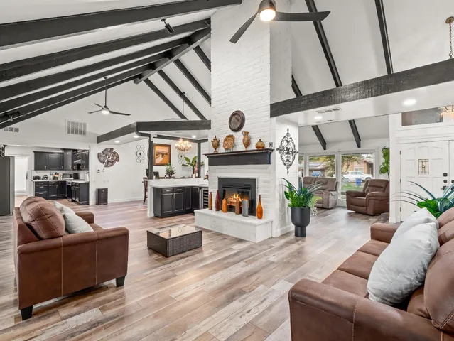 a living room with lots of furniture and a large window