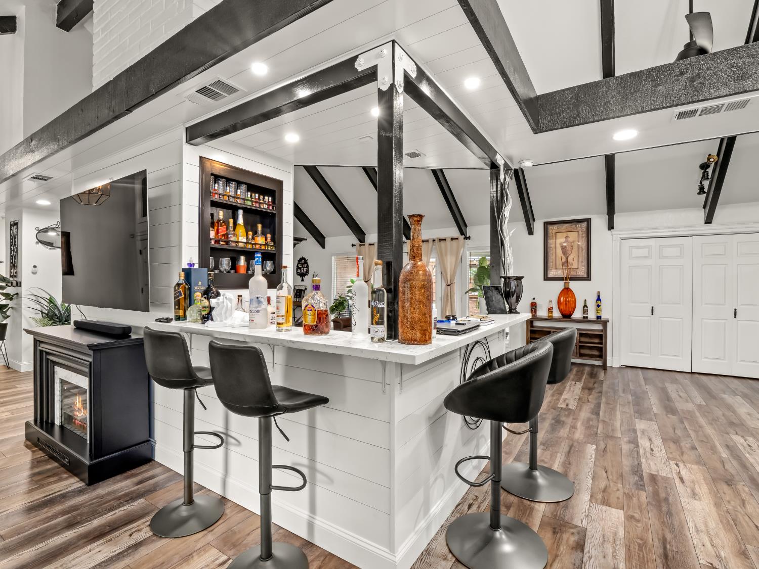 1691 South Bailey Avenue Fresno, CA 93727 - Photo 21 of 41 a kitchen with stainless steel appliances kitchen island granite countertop a table chairs in it and wooden floors