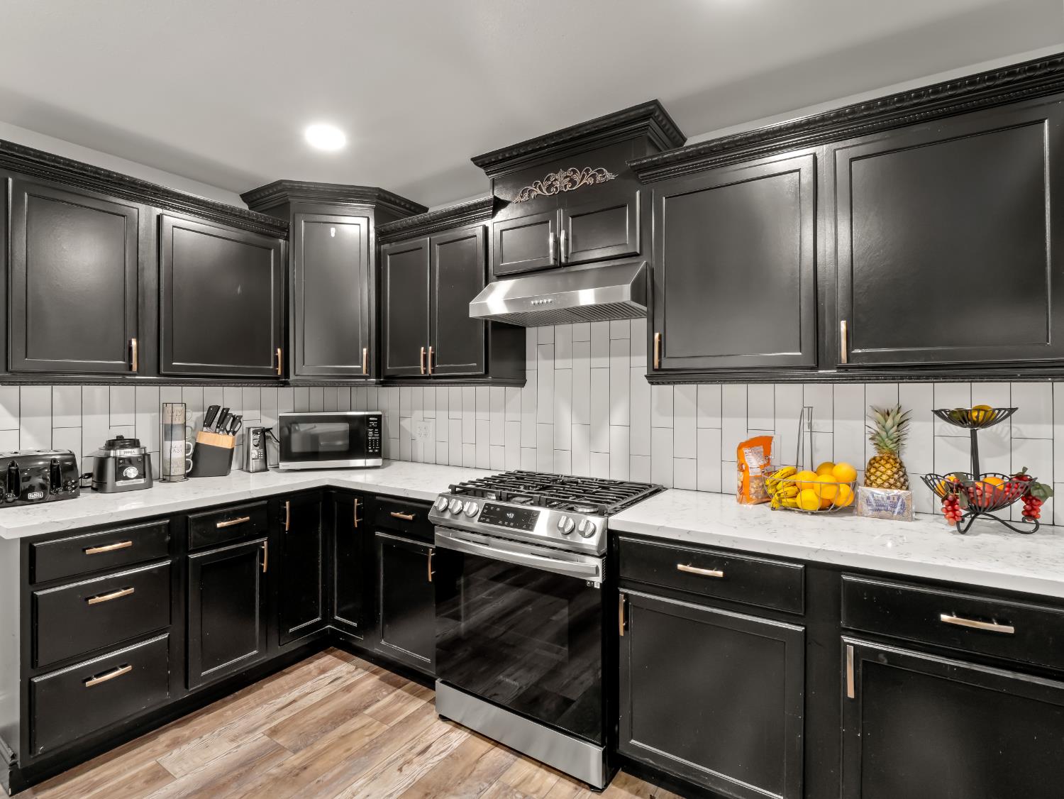 1691 South Bailey Avenue Fresno, CA 93727 - Photo 26 of 41 a kitchen with stainless steel appliances granite countertop a sink stove and cabinets