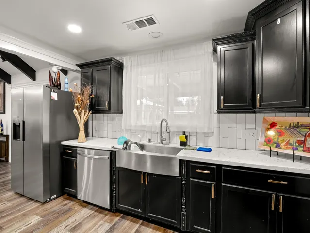 a kitchen with stainless steel appliances granite countertop a stove and a refrigerator