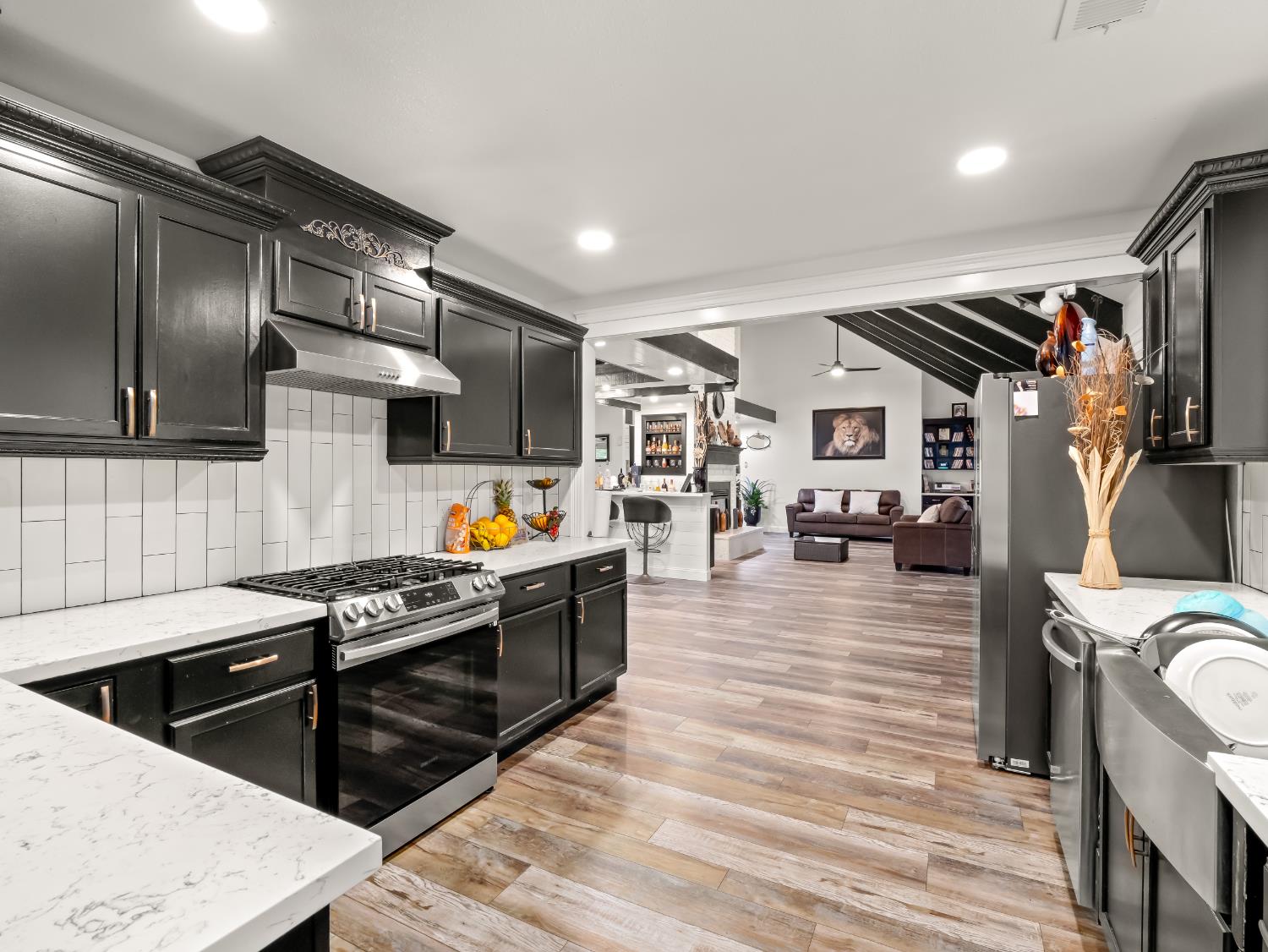 1691 South Bailey Avenue Fresno, CA 93727 - Photo 28 of 41 a kitchen with stainless steel appliances granite countertop a stove and a refrigerator