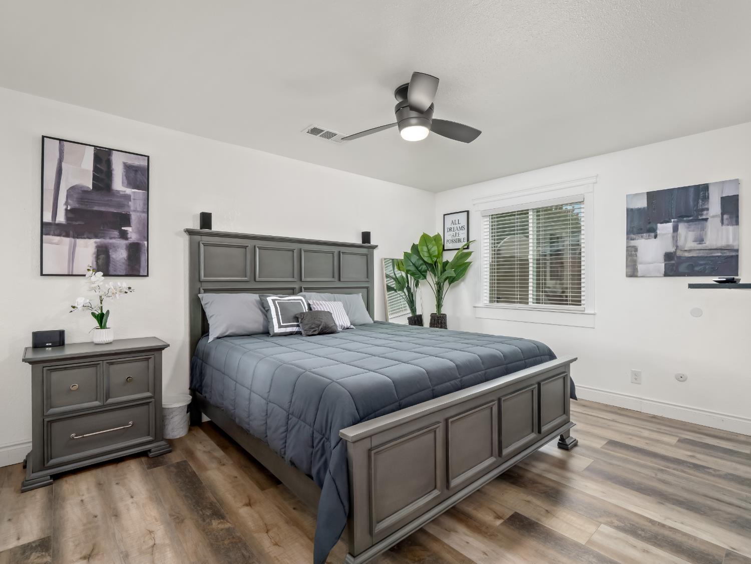 1691 South Bailey Avenue Fresno, CA 93727 - Photo 29 of 41 a bedroom with a bed and a chandelier