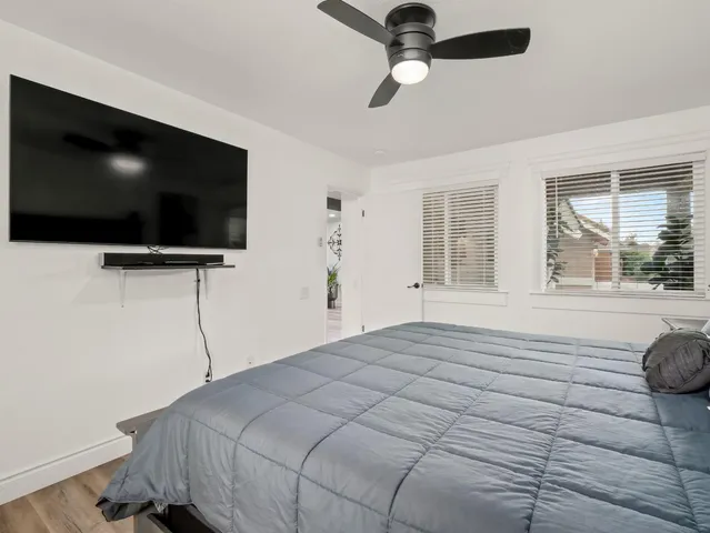a bedroom with a large bed and a chandelier