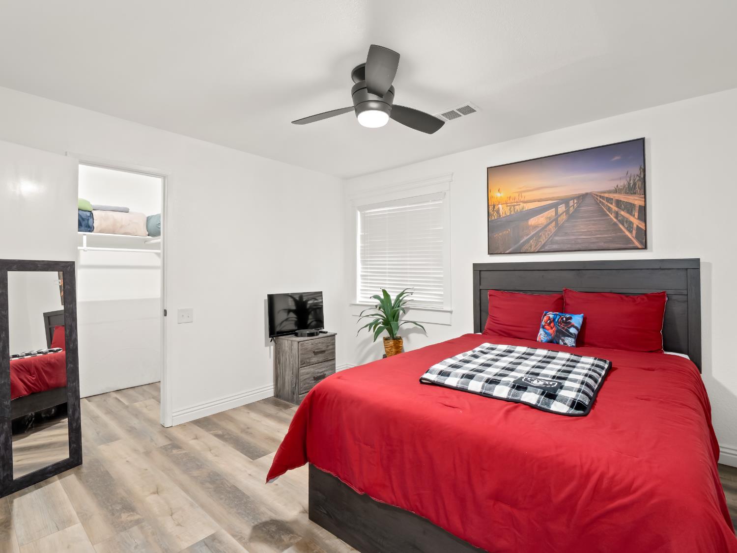 1691 South Bailey Avenue Fresno, CA 93727 - Photo 31 of 41 a bedroom with a large bed and a chandelier