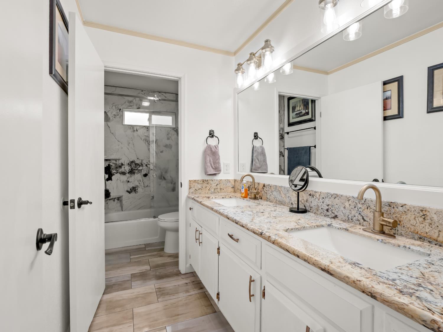 1691 South Bailey Avenue Fresno, CA 93727 - Photo 32 of 41 a bathroom with a granite countertop sink mirror and a bathtub