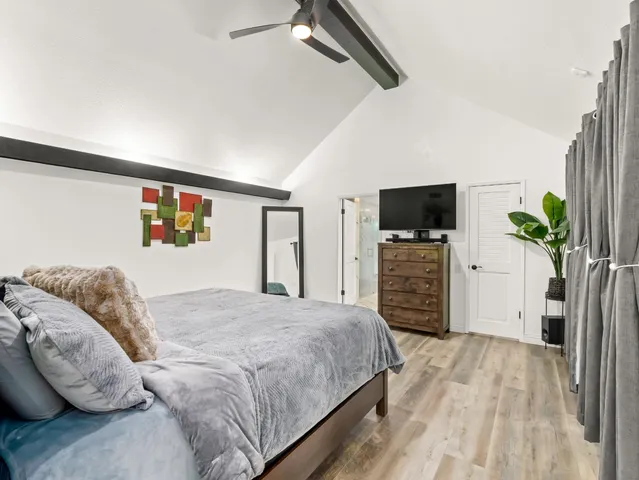 a bedroom with a bed and a television in it