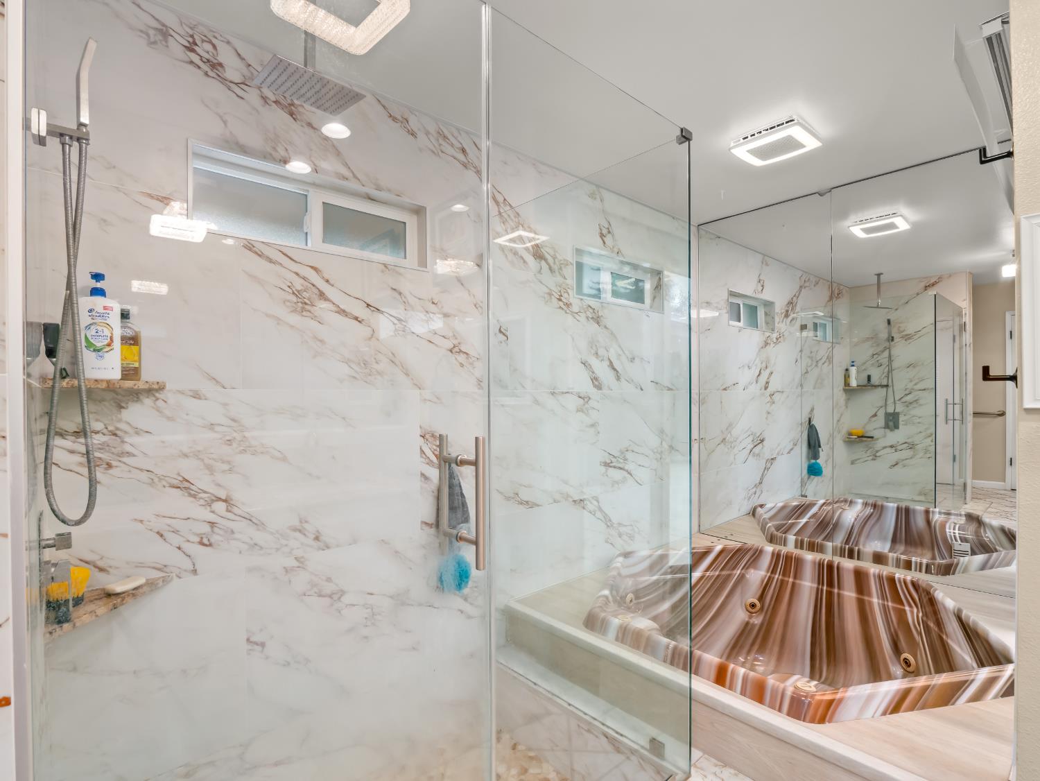 1691 South Bailey Avenue Fresno, CA 93727 - Photo 40 of 41 a bathroom with a sink a mirror and shower