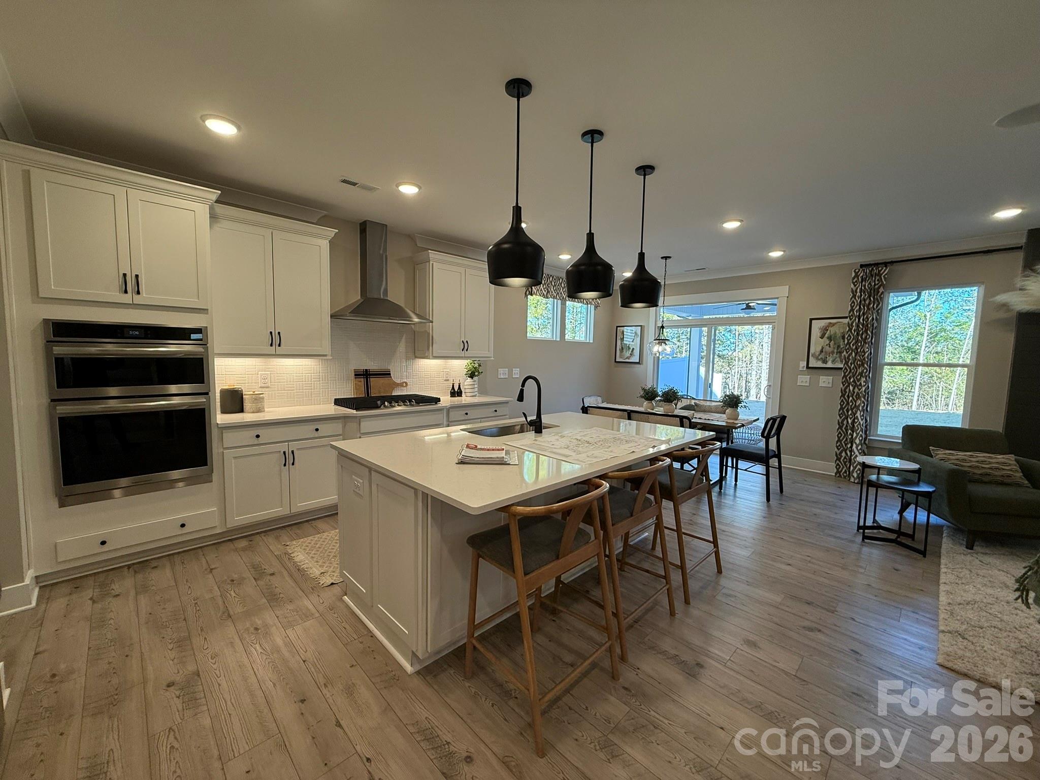 5104 Verona Road Charlotte, NC 28213 - Photo 4 of 28 a kitchen with stainless steel appliances granite countertop a stove a sink dishwasher a refrigerator and a dining table with wooden floor