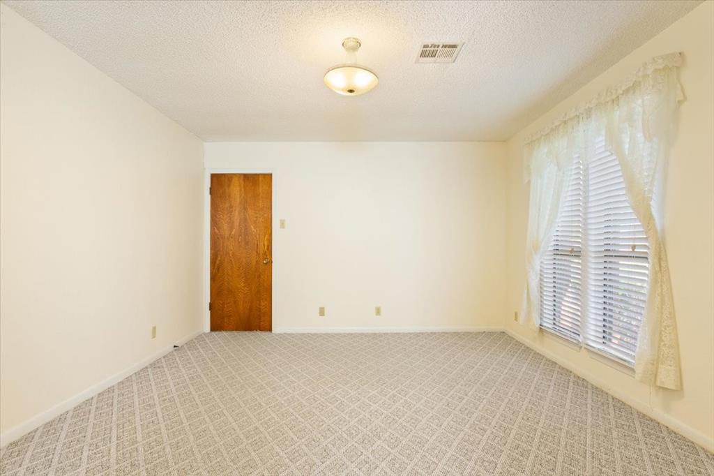 208 South Hedwig Street Riesel, TX 76682 - Photo 19 of 31 Carpeted empty room with a textured ceiling