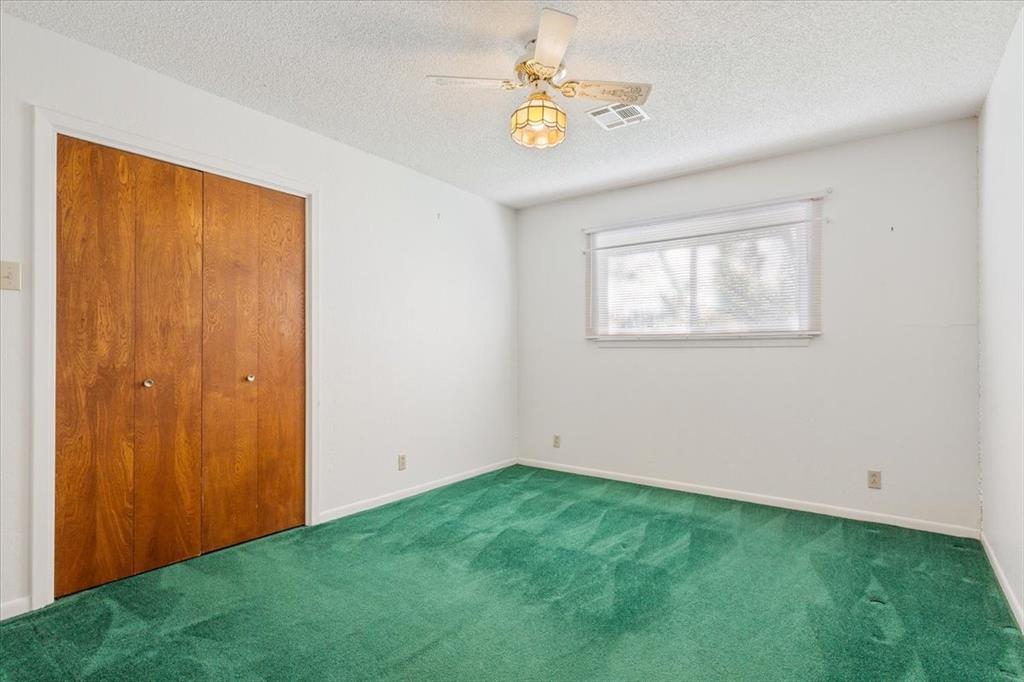 208 South Hedwig Street Riesel, TX 76682 - Photo 23 of 31 Unfurnished bedroom featuring carpet, a textured ceiling, and a closet