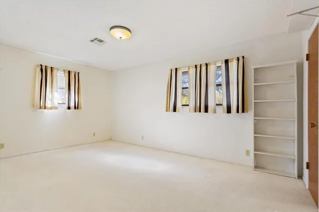 a spacious bathroom with a double vanity sink a mirror and a shower