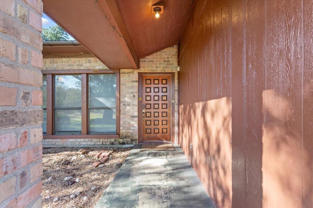 208 South Hedwig Street Riesel, TX 76682 - Photo 5 of 31 Doorway to property featuring stone siding