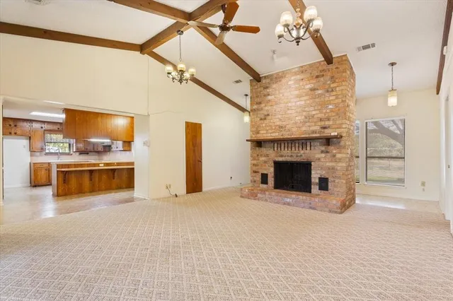 a view of a kitchen with a sink and a fireplace