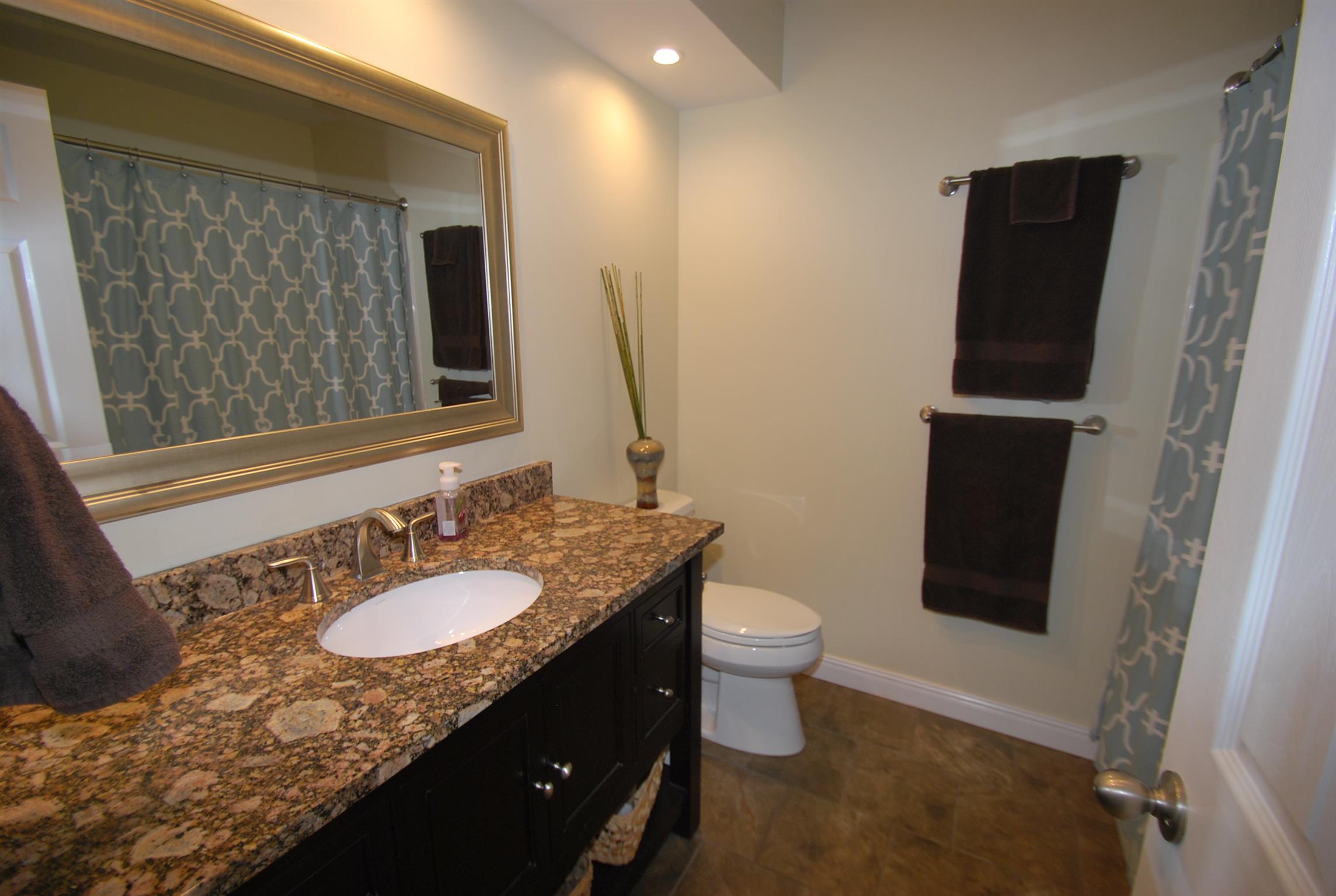 940 North Corinth Road Portland, TN 37148 - Photo 10 of 30 a bathroom with a granite countertop sink toilet and mirror