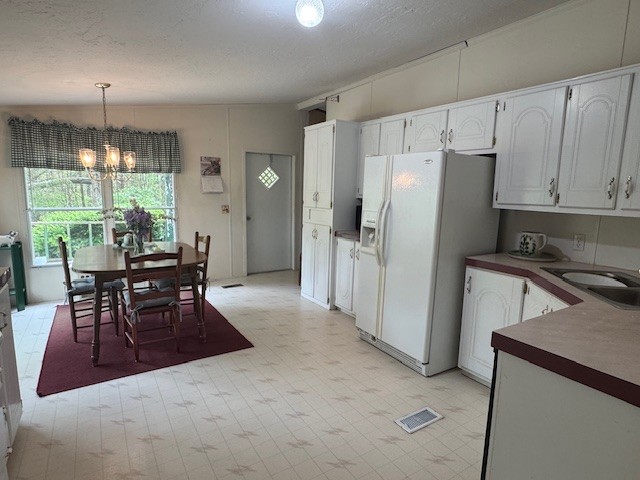 9088 Buck Litton Road Lyles, TN 37098 - Photo 26 of 69 a kitchen with granite countertop a refrigerator a stove a dining table and chairs with wooden floor