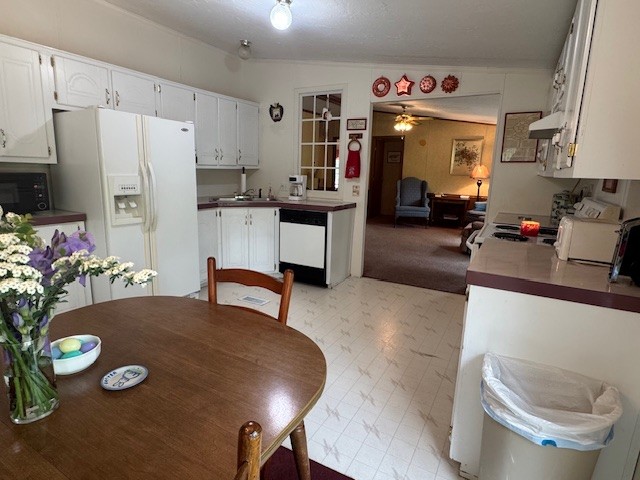 9088 Buck Litton Road Lyles, TN 37098 - Photo 27 of 69 a kitchen with stainless steel appliances dining table and chairs
