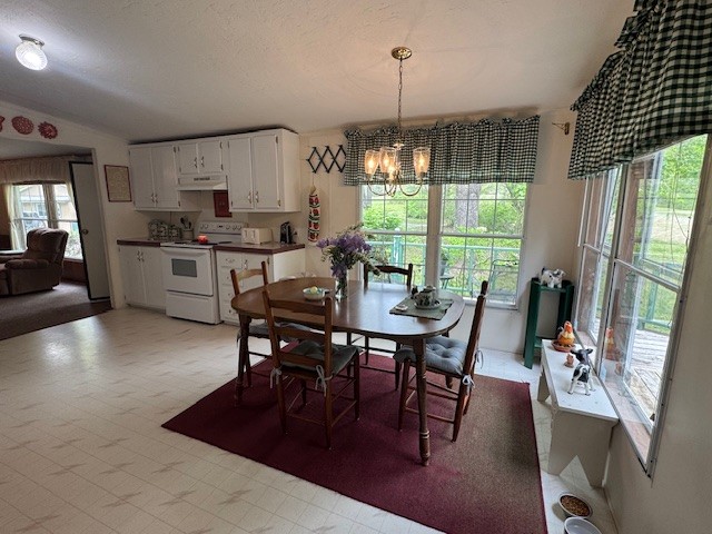 9088 Buck Litton Road Lyles, TN 37098 - Photo 30 of 69 a open kitchen with stainless steel appliances granite countertop a stove a refrigerator a dining table and chairs with wooden floor