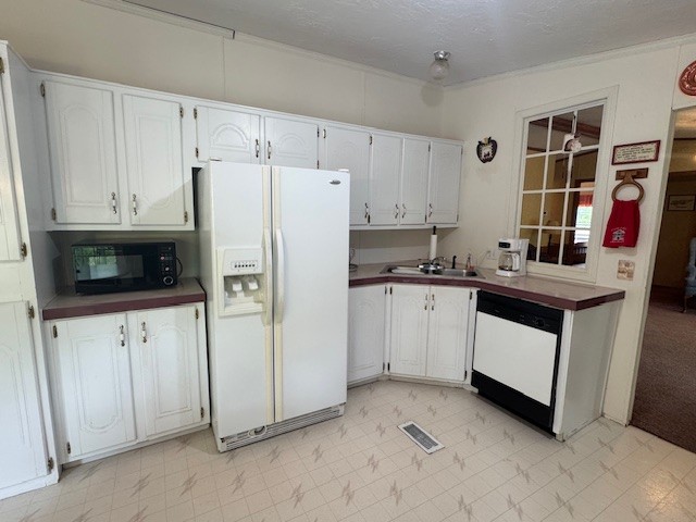 9088 Buck Litton Road Lyles, TN 37098 - Photo 31 of 69 a kitchen with white cabinets and white appliances
