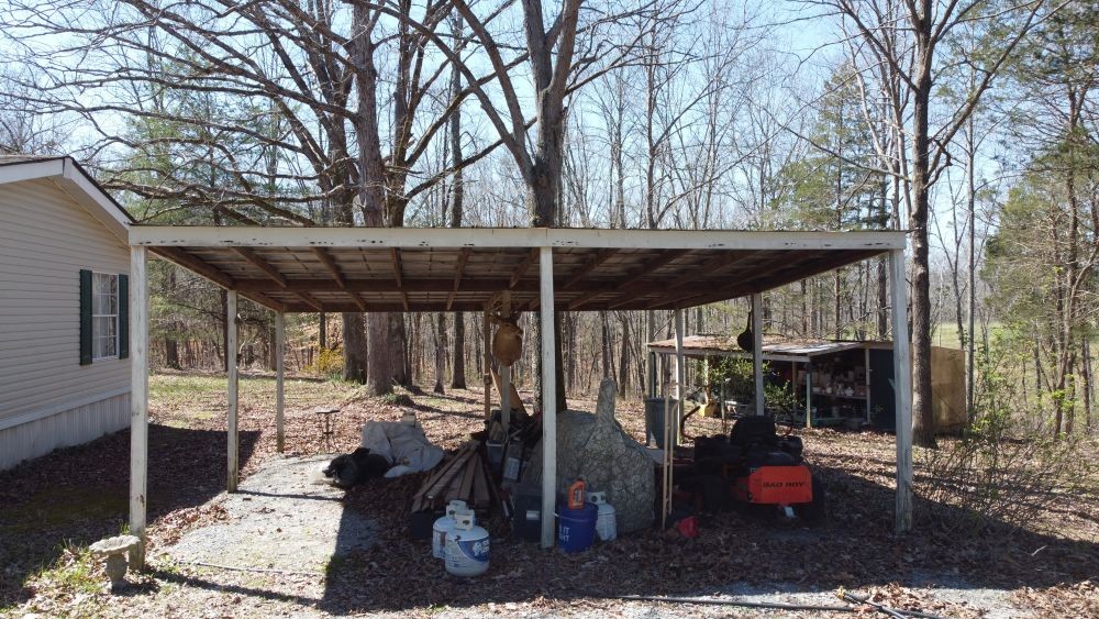 9088 Buck Litton Road Lyles, TN 37098 - Photo 69 of 69 a view of a patio with table and chairs under an umbrella with large tree