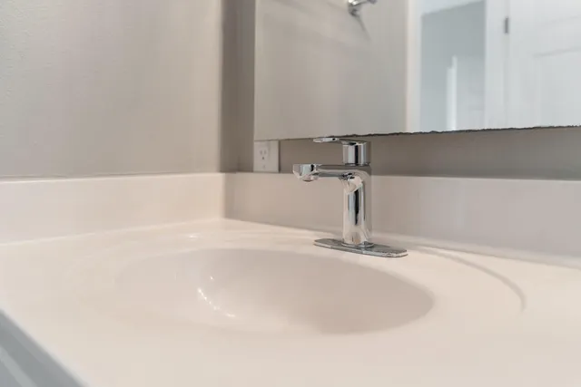 a view of an empty room with cabinet and a fireplace
