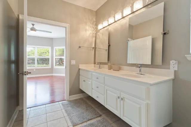 an empty room with windows and fireplace